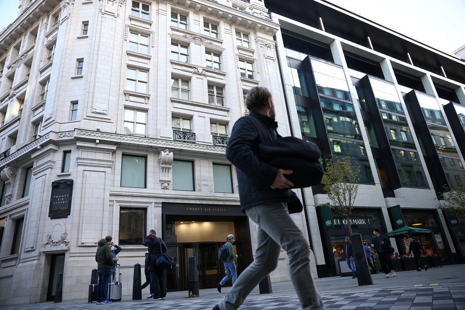 People walk past the building containing the Twitter UK headquarters in central London, Britain