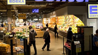 Customers wander into the fruit and vegetable section of the Edeka branch of the Rindermarkthalle.
