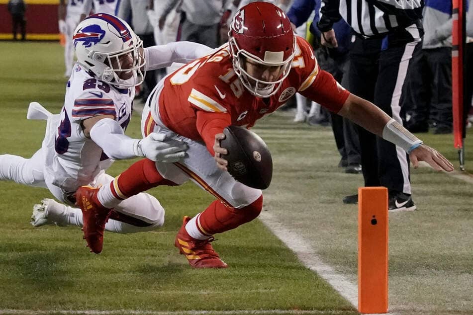 Kansas City Chiefs quarterback Patrick Mahomes (right) overpowers the Buffalo Bills Micah Hyde's safety for a touchdown.