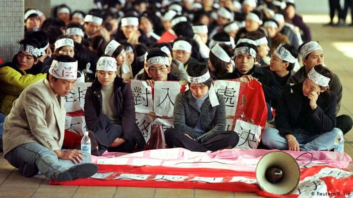 This 1999 photo shows Chinese visitors protesting after their residence permit was denied.