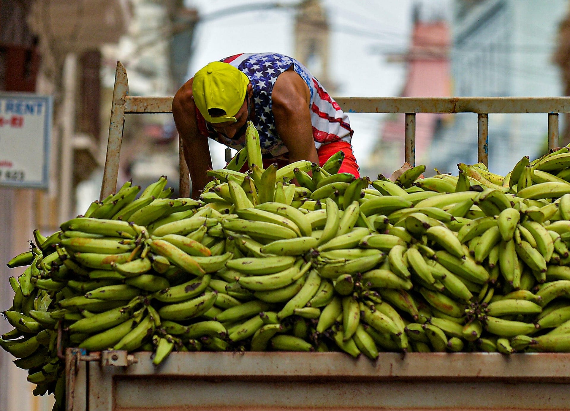 A Cuban unloads a load of bananas to sell in Havana, July 15, 2021.