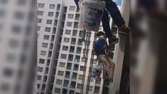 [VIDEO]    A woman cut a rope carrying the painters 26 floors of the building