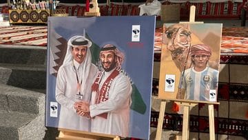 The painting with Sheikh Tamir bin Hamad bin Khalifa Al Thani (left) and Crown Prince Mohammed bin Salman next to camel driver Diego Maradona.